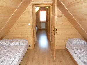 a room with two beds in a wooden cabin at DOMKI CZYRNA SZCZYRK in Szczyrk