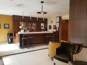 a lobby with a bar with stools at Résidence Sénior Villa Sully Seynod-Annecy in Annecy