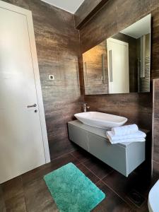 a bathroom with a sink and a mirror at Luxury Laurus Penthouse with awesome sea view in Primošten