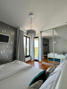a bedroom with a large bed and a large window at Luxury Laurus Penthouse with awesome sea view in Primošten