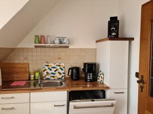 a kitchen with a sink and a counter top at Ferienwohnung Haus Fischer in Langwedel