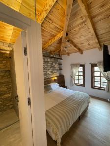 a bedroom with a bed in a room with wooden ceilings at N'Gorice in Berat