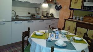 una cucina con tavolo e tovaglia bianca di B&B Via Spalti 52 a Trapani