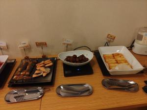 a table topped with food and a bowl of food at Hotel Hakusan Hills in Hakusan