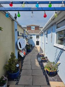 an alley with colorful lights on the side of a house at Hayling Hideaway, private cosy annex near to beach in South Hayling