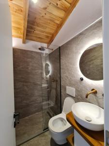 a bathroom with a white toilet and a sink at N'Gorice in Berat