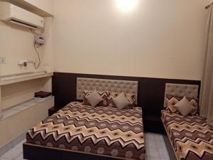 a bedroom with a bed with pillows on it at Scindhia Guest House in Varanasi