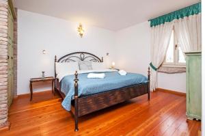 a bedroom with a bed and a wooden floor at Apartments Casa Rubeus Rovinj in Rovinj