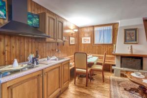 a kitchen with a sink and a table with a dining room at B&B San Rocco in Capo di Ponte