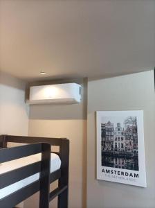 a bedroom with a bed and a picture on the wall at AmsterHome Hotel in Amsterdam