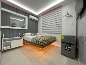 a bedroom with a bed and a sink in it at Alegria Hostal in Santiago de los Caballeros