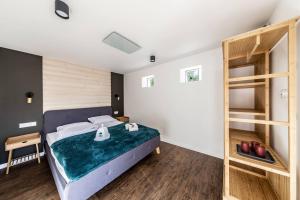 a bedroom with a bed and a book shelf at Kadyny Apartments 37B in Kadyny