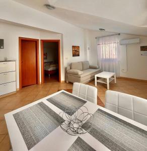 a kitchen and living room with a table and chairs at Apartments SARA in Medulin