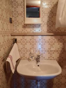 a bathroom with a sink and a mirror at Apartment Anić in Šmrika