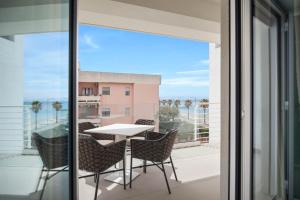 a balcony with a table and chairs and a view at Seaside Hotel in Capo dʼOrlando +66 photos