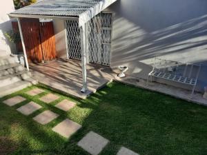 a house with a porch with a green lawn at Little Milner Cottage in Queenstown