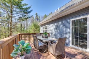 a patio with a table and chairs on a deck at Chic Wisconsin Retreat with Deck, Grill and Fire Pit! in Wisconsin Dells