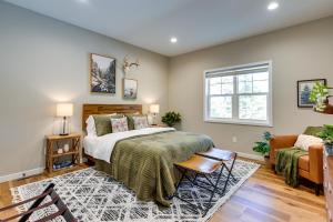 a bedroom with a bed and a couch and a window at Chic Wisconsin Retreat with Deck, Grill and Fire Pit! in Wisconsin Dells