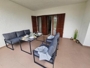 a living room with a table and chairs at Jandom in Malinska