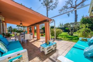 a patio with blue couches and a table at Ideal Property Mallorca - Can Caragol Inca in Inca