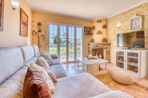 a living room with a couch and a fireplace at Ideal Property Mallorca - Can Caragol Inca in Inca