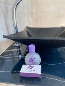 uma garrafa de elixir bucal sentada ao lado de um lavatório em Hotel Boituva Inn - Your Hotel em Boituva