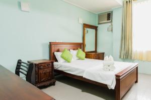 a bedroom with a bed and a table and a mirror at Asian Residencies - Grandpass in New Bazaar