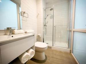 een witte badkamer met een toilet en een douche bij Encantador Depto tipo Studio en Lastarria Servicio HOM in Santiago