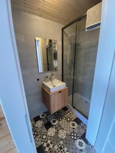 a bathroom with a sink and a shower at RYBY W SIECI in Władysławowo