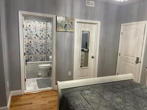 a bedroom with a bed and a bathroom with a shower at Brand New Luxury Rooms near downtown Boston in Boston +21 photos