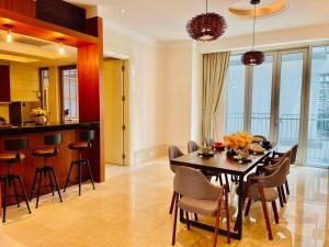a dining room and kitchen with a table and chairs at 14 Pax Stylish Homestay 3 min walk to KLCC#10 min walk to Pavilion in Kuala Lumpur