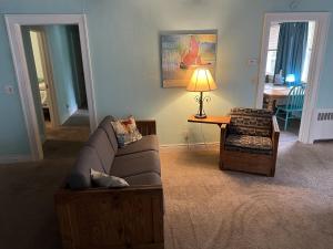 a living room with a couch and a table at Historic Beach Side Getaway - Pet friendly, WiFi cottage in Norfolk