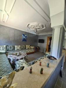 a large room with couches and tables in a building at Dar Babou in Rabat