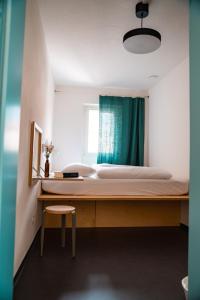 a bedroom with a bed with a desk and a chair at Bogentrakt in Chur