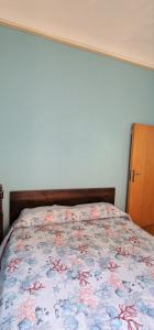 um quarto com uma cama com colcha floral em Apartment Martina em Imperia
