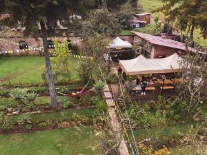 an aerial view of a resort with a hammock in a garden at Kinti Wasi Casa de Campo in Los Baños del Inca