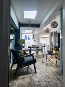 a living room with a couch and a table at Stunning seaside cottage seconds from beach by Whitstable-Holidays, Fig Cottage in Whitstable