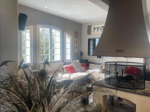 a living room with a couch and a table at DOMAINE DES PEYRIES - Chambres et table d'hôtes in Saint-Barthélémy-dʼAgenais