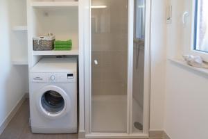 a white washer and dryer in a bathroom at Ferienhaus Neptun Norddeich in Norddeich