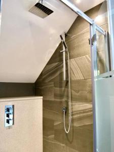 a shower with a glass door in a bathroom at Luxury holiday home sleeps 8-12 W/Hot Tub in Worcester