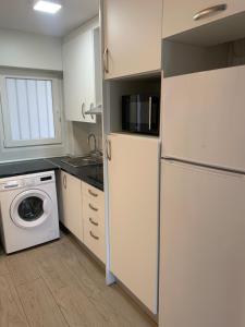 a kitchen with a refrigerator and a washing machine at Apartment Ducado 41 Benidorm Playa levante 4 P in Benidorm