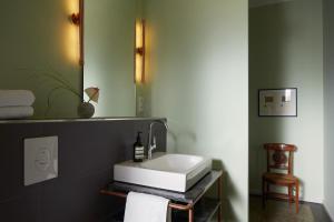 a bathroom with a white sink and a mirror at Wil7 Boutique Hotel in Berlin +37 photos