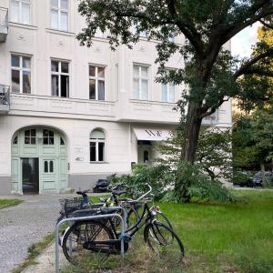 two bikes parked next to a tree in front of a building at Wil7 Boutique Hotel in Berlin