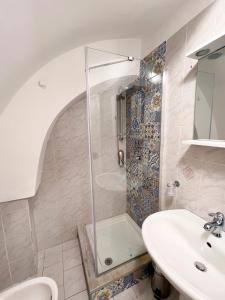 a bathroom with a shower and a sink at Calilla house by Procida Reserve in Procida +22 photos