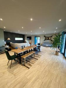 a large living room with a table and a couch at Villa Giulia in Montjoie-en-Couserans