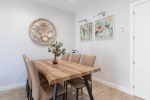 a dining room with a wooden table and chairs at Los Alamos Beach Flat in Torremolinos