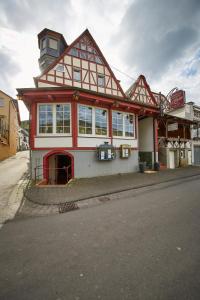 a large house with a red and white at Gästehaus Zur Traube in Reil