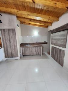 Il comprend une cuisine avec un évier et un plafond en bois. dans l'établissement Alquilo Casa Luminosa y Amplia en Viedma, à Viedma