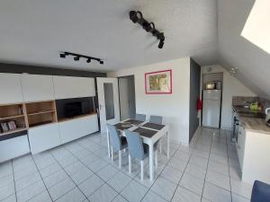 a kitchen and dining room with a table and chairs at Appartement T2 45m² avec terrasse - 4/6 personnes in Le Mont-Dore