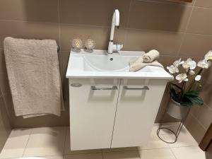 a bathroom with a white sink and a mirror at Luxury Old Town Apartment with Sea View in Rogoznica +34 photos